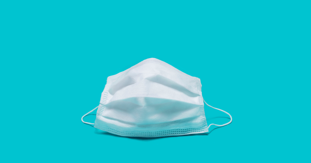 An image of a face mask against a blue background