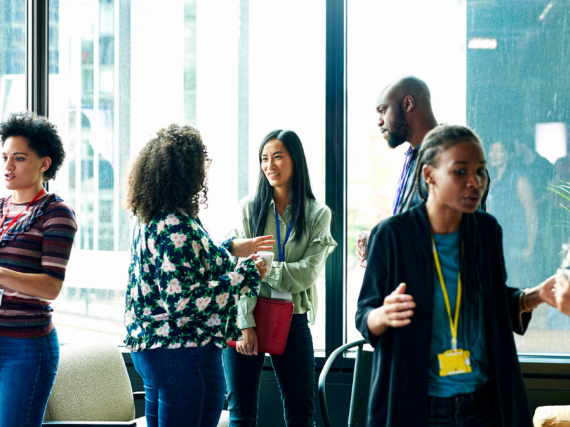 A diverse group of people discuss new ideas