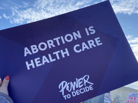 Power to Decide staff holding signs at the rally. 