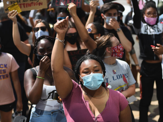 An image of protesters with signs that read, "Black Lives Matter."