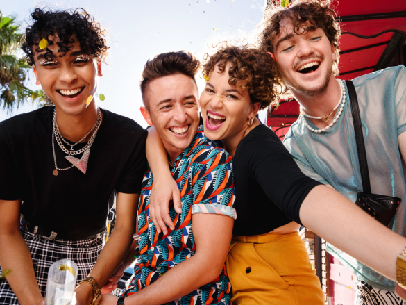 Friend group hugging and laughing.